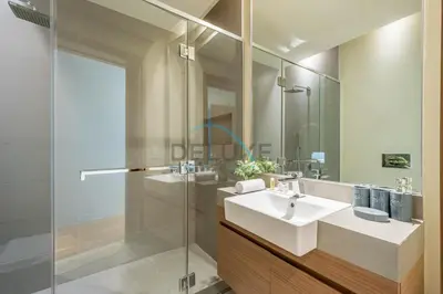 a bathroom with a sink and a glass shower at Radiant 2BR with Assistant Room at Citywalk Residential Building 7, Al Wasl by Deluxe Holiday Homes in Dubai