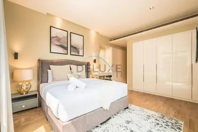 a bedroom with a large white bed and a closet at Radiant 2BR with Assistant Room at Citywalk Residential Building 7, Al Wasl by Deluxe Holiday Homes in Dubai