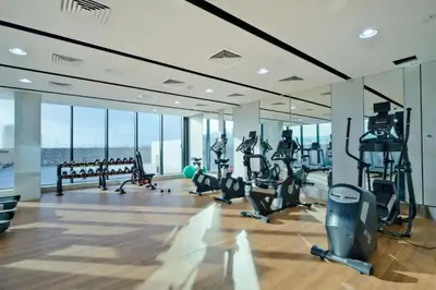 a gym with treadmills and exercise equipment in a building at Modern Studio in JVC, Near Parks and Highways in Dubai