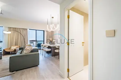 a living room with a couch and a table at Luxurious 2BR Apartment at Sadaf 6, Jumeirah Beach Residence by Deluxe Holiday Homes in Dubai