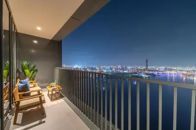 a room with a balcony with a view of the city at Frank Porter - Creek Edge Tower 1 in Dubai