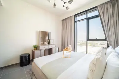 a bedroom with a large bed and a large window at Frank Porter - Creek Edge Tower 1 in Dubai