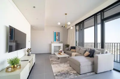 a living room with a couch and a tv at Frank Porter - Creek Edge Tower 1 in Dubai