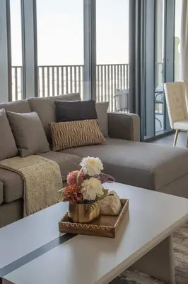a living room with a couch and a table at Frank Porter - Creek Edge Tower 1 in Dubai