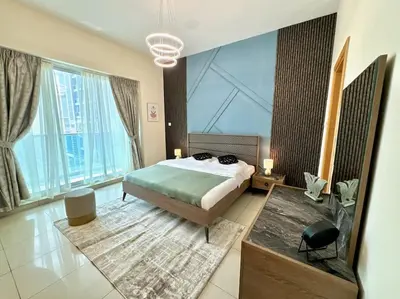 a bedroom with a bed and large windows at Renovu Exclusive Residences in Dubai in Dubai