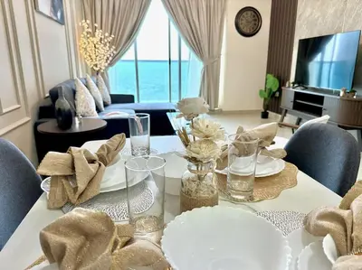 a living room with a table with chairs and a couch at Renovu Exclusive Residences in Dubai in Dubai
