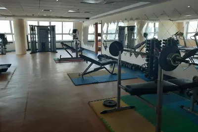 a gym with several tread machines in a room at Renovu Exclusive Residences in Dubai in Dubai