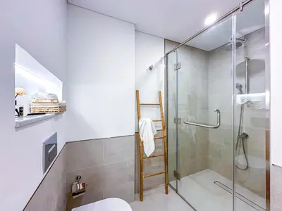 a bathroom with a glass shower and a toilet at Ultra Luxury Flat with Amazing Pool Near to Burj in Dubai