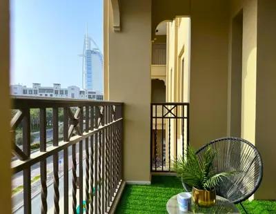 a balcony with a table and a plant at Ultra Luxury Flat with Amazing Pool Near to Burj in Dubai