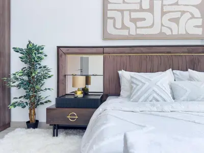 a bedroom with a bed and a table with a mirror at Ultra Luxury Flat with Amazing Pool Near to Burj in Dubai