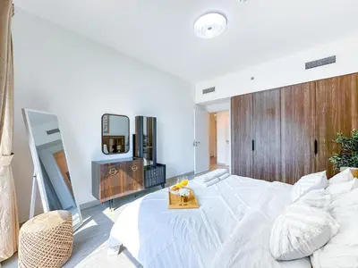 a bedroom with a large white bed and a mirror at Ultra Luxury Flat with Amazing Pool Near to Burj in Dubai