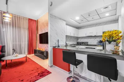 a kitchen with a red and white counter top at Dubai Marina 3BR Penthouse with Stunning JBR, Marina & Dubai Eye Views in Dubai