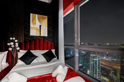 a bedroom with a large window with a bed in front of it at Dubai Marina 3BR Penthouse with Stunning JBR, Marina & Dubai Eye Views in Dubai