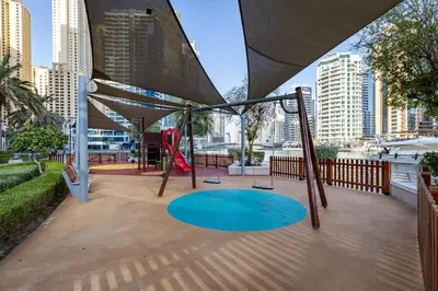a playground in a city with a swing at Dubai Marina 3BR Penthouse with Stunning JBR, Marina & Dubai Eye Views in Dubai