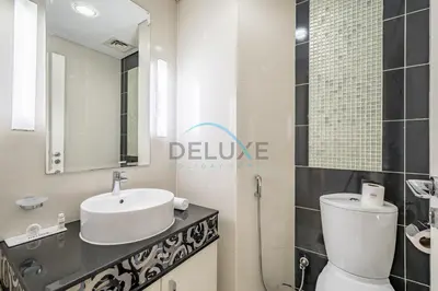 a bathroom with a white toilet and a sink at Whimsical 3BR at The Signature, Downtown Dubai by Deluxe Holiday Homes in Dubai
