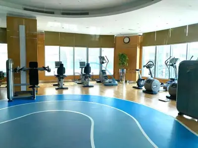 a fitness room with a gym with a blue floor at Whimsical 3BR at The Signature, Downtown Dubai by Deluxe Holiday Homes in Dubai