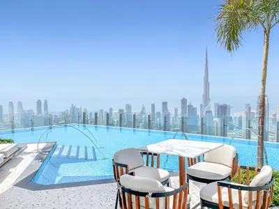 a table and chairs next to a swimming pool at Infinity luxury in Dubai