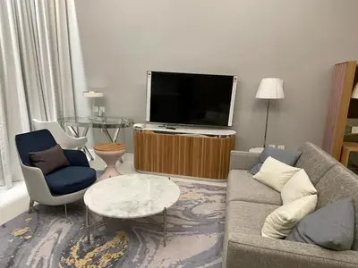 a living room with a couch and a flat screen tv at Infinity luxury in Dubai