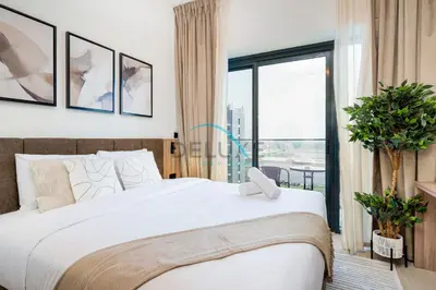 a bedroom with a large bed and a large window at Cozy Studio in Azizi Riviera 44, Al Merkadh by Deluxe Holiday Homes in Dubai