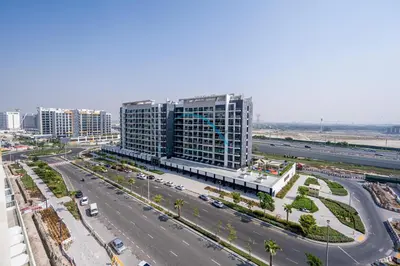 an aerial view of a large building with a highway at Cozy Studio in Azizi Riviera 44, Al Merkadh by Deluxe Holiday Homes in Dubai