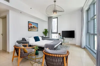 a living room with a couch and a tv at Burj Khalifa Views - 5 min walk from Dubai Mall - Upgraded - Designer Choice - 8 people - Dubai Opera in Dubai