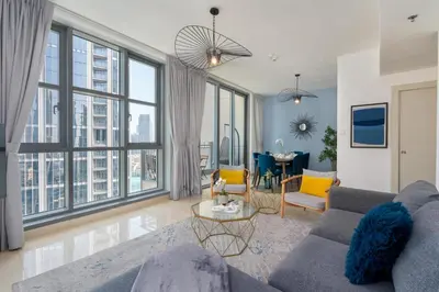 a living room with a couch and a table at Burj Khalifa Views - 5 min walk from Dubai Mall - Upgraded - Designer Choice - 8 people - Dubai Opera in Dubai