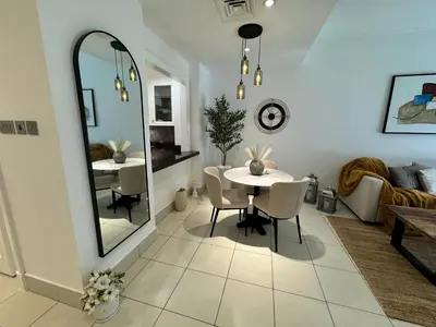 a dining room with a table and a mirror at Luxurious 1BR Aprt Burj Khalifa Area in Dubai