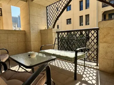 a balcony with a table and a bench on a balcony at Luxurious 1BR Aprt Burj Khalifa Area in Dubai