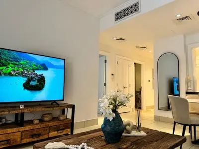 a living room with a large flat screen tv at Luxurious 1BR Aprt Burj Khalifa Area in Dubai