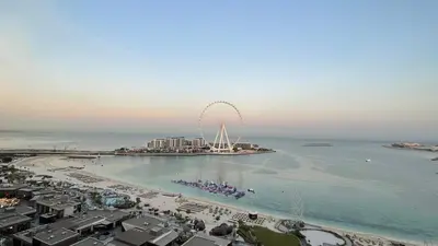 a beach with a ferris wheel in the water at JBR Beachfront Luxe apartment all Rooms Sea Facing in Dubai
