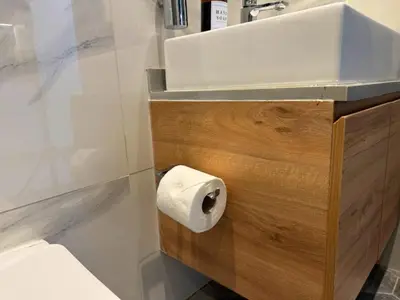 a bathroom with a sink and a roll of toilet paper at kinda Holiday Homes- Mag 318 Downtown in Dubai