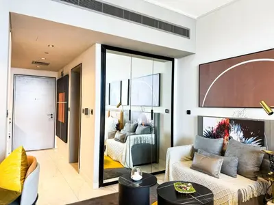 a living room with a couch and a bedroom at kinda Holiday Homes- Mag 318 Downtown in Dubai