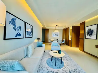 a living room with a couch and a table at Skyline Retreat 3 Bedroom at Address Opera I Burj Khalifa & Fountain Views in Dubai
