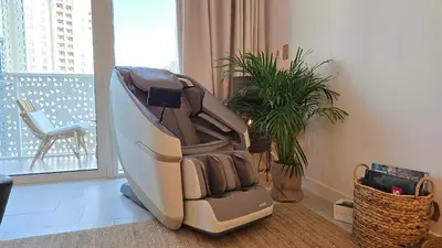 a massage chair sitting in a room next to a window at Private Spa 1BR Biophilic Retreat With Beach Access & Infinity Pool in Dubai