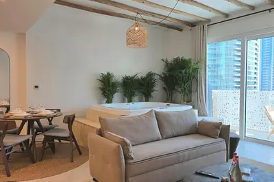 a living room with a couch and a tub at Private Spa 1BR Biophilic Retreat With Beach Access & Infinity Pool in Dubai