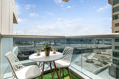 a white table and chairs on a balcony with a view at Elegant 3BR Lux Stay in the Heart of Dubai Marina in Dubai