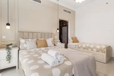 a bedroom with two beds with white towels at Elegant 3BR Lux Stay in the Heart of Dubai Marina in Dubai