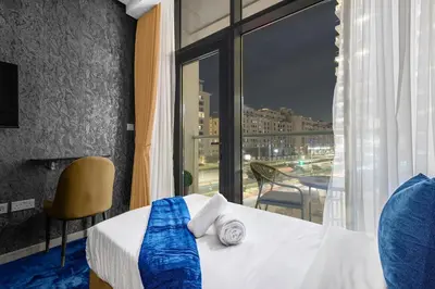 a hotel room with a bed and a large window at Beachfront 1 Bedroom Apartment on Palm Jumeirah with Stunning Sea Views and Rooftop Infinity Pool in Dubai