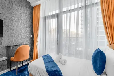 a hotel room with a bed and a window at Beachfront 1 Bedroom Apartment on Palm Jumeirah with Stunning Sea Views and Rooftop Infinity Pool in Dubai