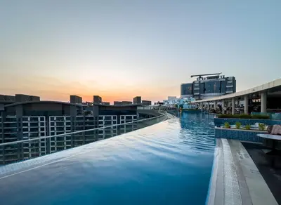 a swimming pool on the roof of a building at Beachfront 1 Bedroom Apartment on Palm Jumeirah with Stunning Sea Views and Rooftop Infinity Pool in Dubai