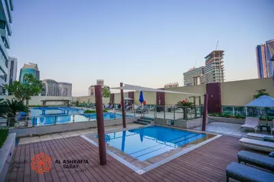 a pool on the roof of a building at Alashrafia Saray- Upscale 1bdr apartment in Canal Views in Dubai