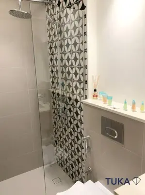 a bathroom with a shower with a glass door at Stunning 2-BHK Golfville at Dubai Hills Prime in Dubai
