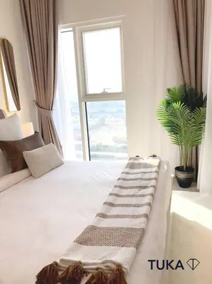 a bedroom with a large white bed with a window at Stunning 2-BHK Golfville at Dubai Hills Prime in Dubai