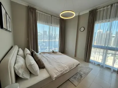 a bedroom with a large bed and a large window at 1BR in Mayfair tower Business bay! Burj views, close to Dubai mall in Dubai