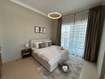 a bedroom with a bed and a large window at 1BR in Mayfair tower Business bay! Burj views, close to Dubai mall in Dubai