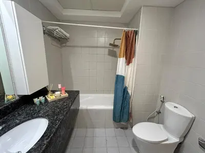 a bathroom with a toilet and a sink and a tub at 1BR in Mayfair tower Business bay! Burj views, close to Dubai mall in Dubai
