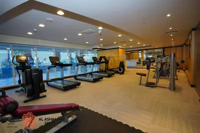 a gym with treadmills and ellipticals in a building at Alashrafia Saray- Peaceful studio in Canal Views in Dubai