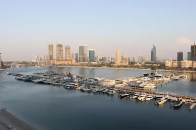 a group of boats docked at a marina in a city at 2BR Beachfront Living, Stunning Marina Views in Dubai