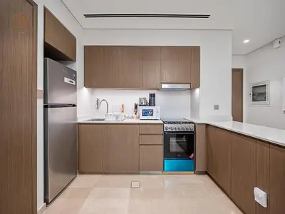 a kitchen with wooden cabinets and a stove top oven at Luxury Home with City Views Near Dubai Mall 196GR-1 in Dubai