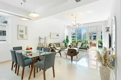a living room with a table and chairs at DAYF-ALI City's Heart Chic 1 BR Huge Terrace and Great Access in Dubai